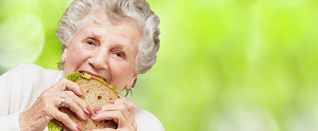 Senior Woman Eating Sandwich