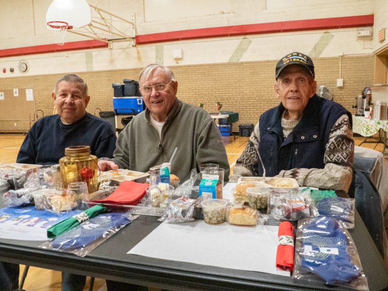 Three men eating at the DTE Holiday Meal