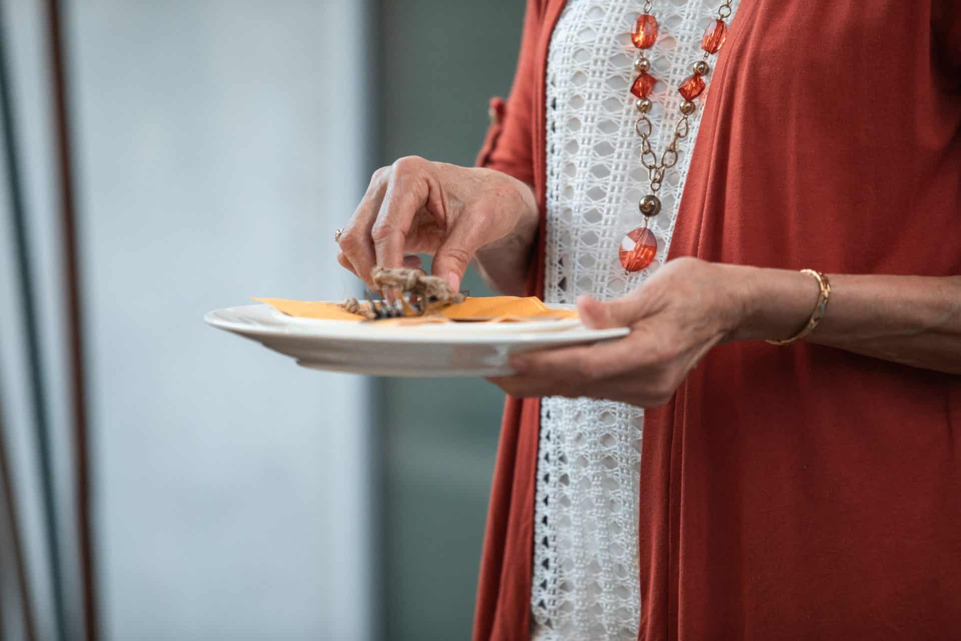 woman holding plate of food