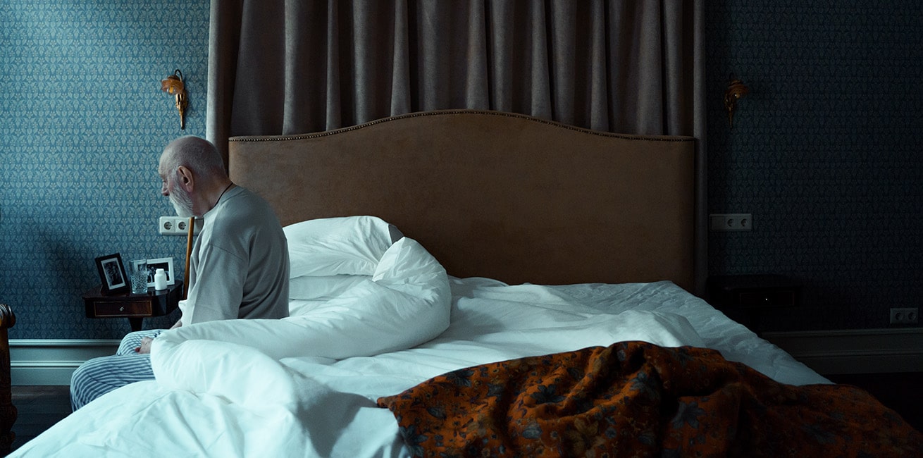 sad man on bed