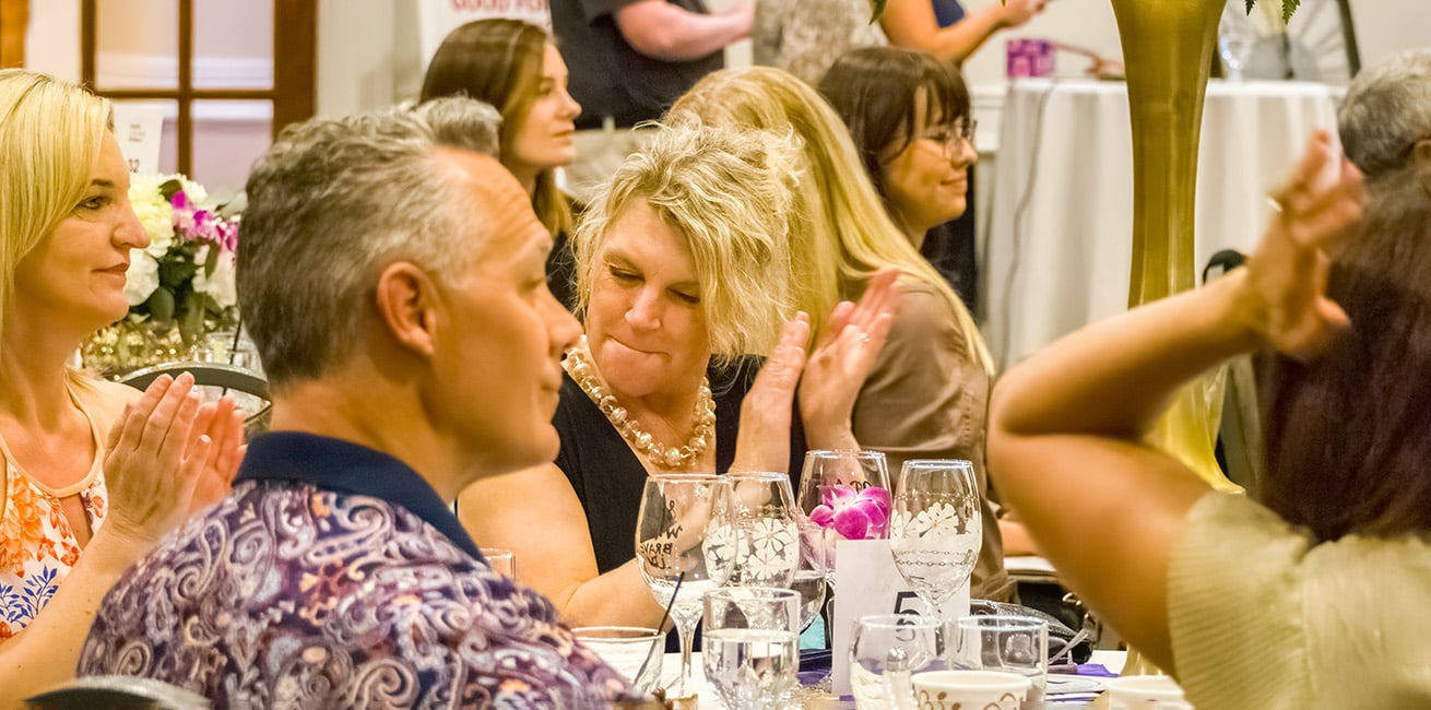 Woman clapping at Heels for Meals and More 2023