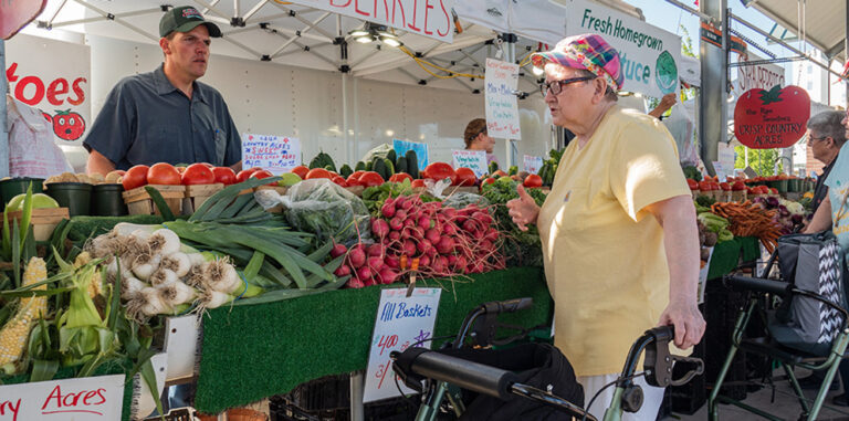 A woman with a walker at the farmer's market