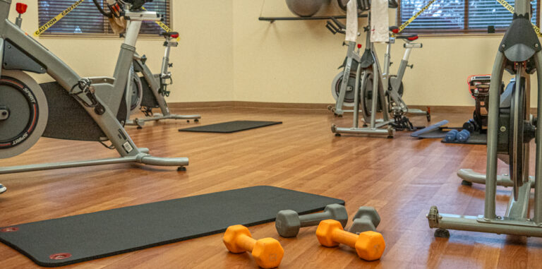 Exercise room with spin bikes, weights and exercise mats