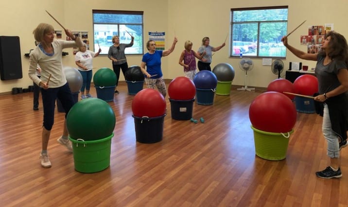 senior community activity of drumming